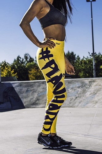 TREC WEAR - żółte legginsy damskie z czarnym napisem